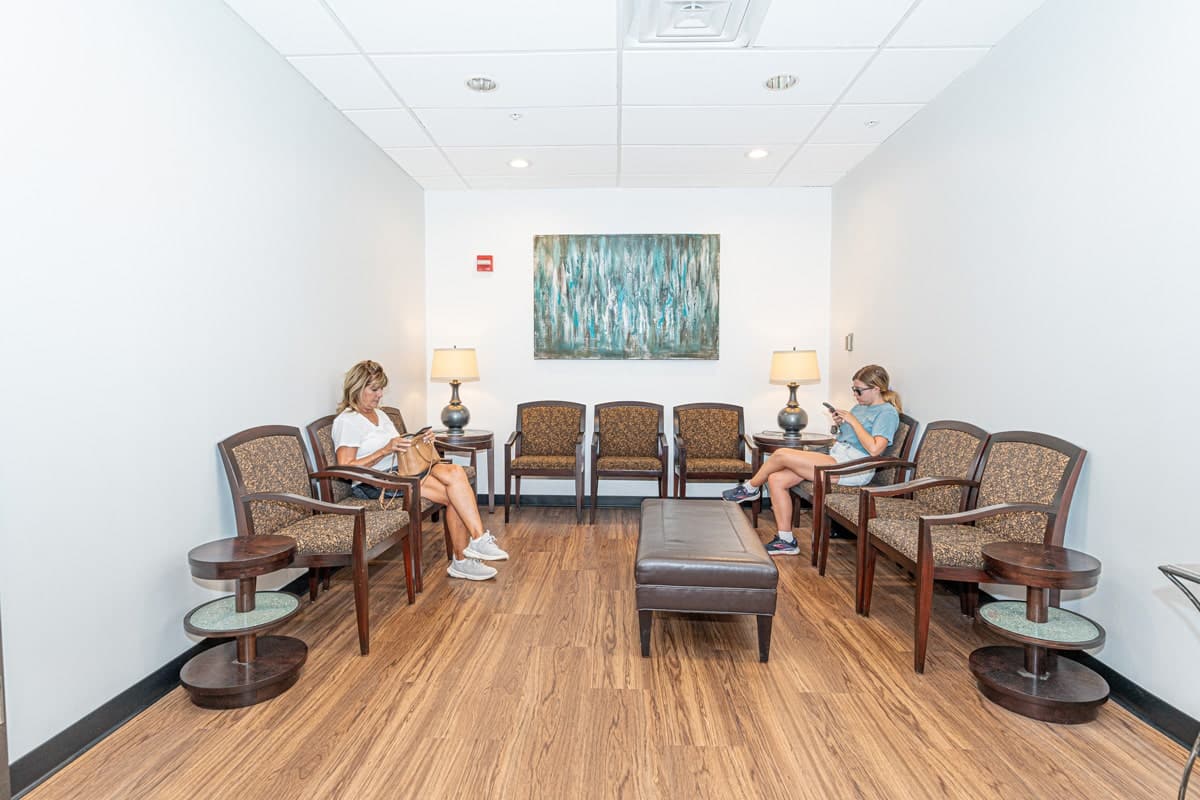 Two patients sitting in the Smile On Dental Studio waiting room