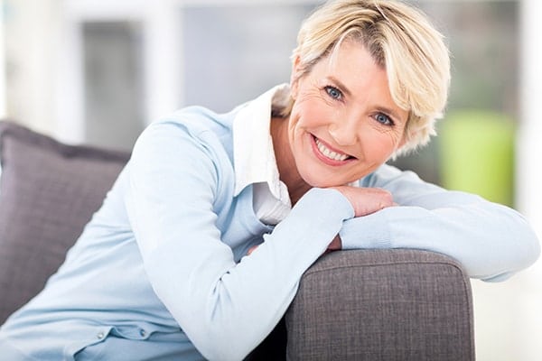 mature woman relaxing at home on her couch
