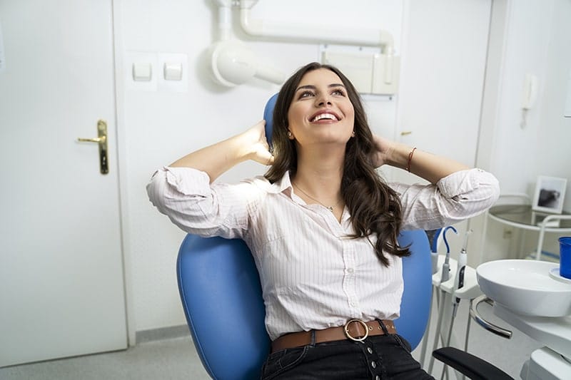 Gorgeous young adult woman keeping calm at her visit at dentist