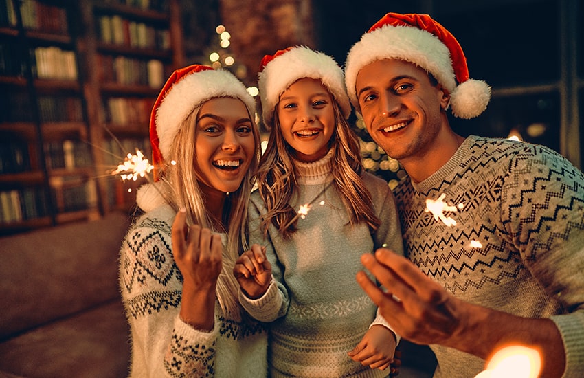 Young family celebrates the holidays together with a smile