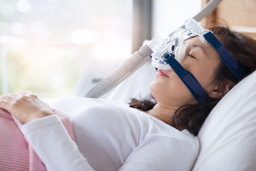 woman sleeping with cpap mask on 